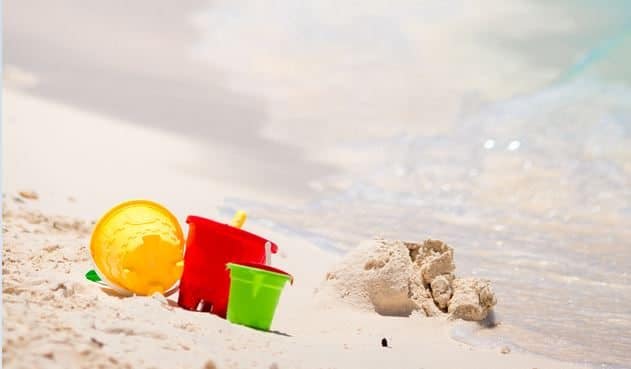 Children's Beach Toys Near The Waves On A Sandy Beach