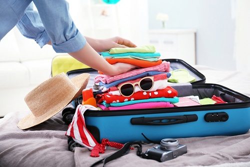 Woman packing suitcase for a holiday
