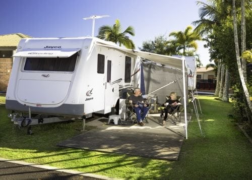 A Couple Enjoying Their Holiday In Front Of Their Caravan At Brisbane Holiday Village