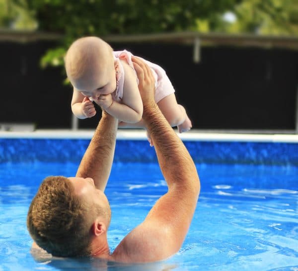 Man and Baby in Pool Playing