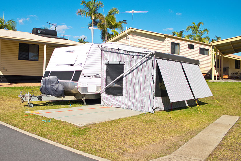 Side view of a caravan camp setup on a 7m to 9m caravan site at Brisbane Holiday Village