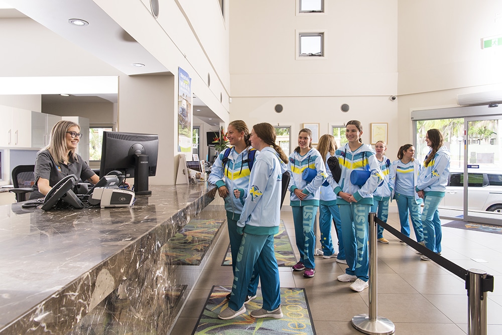 School sports team checking into group accommodation in Reception at Brisbane Holiday Village