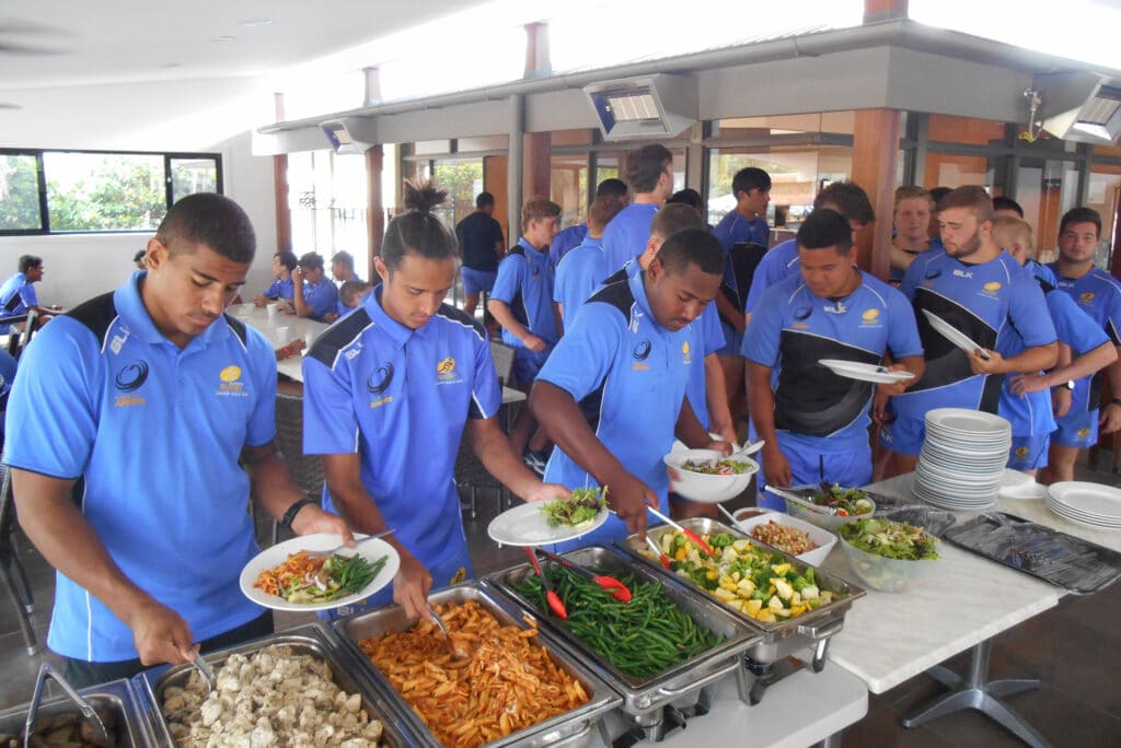 Boys sporting group team enjoying a buffet lunch at Lagoona Resort Restaurant, while staying in group accommodation at Brisbane Holiday Village